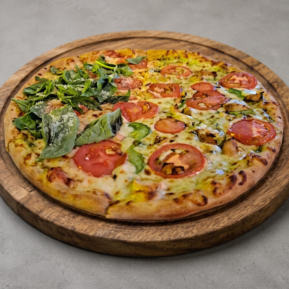 Half-and-half pizza with arugula and tomatoes on a wooden board.